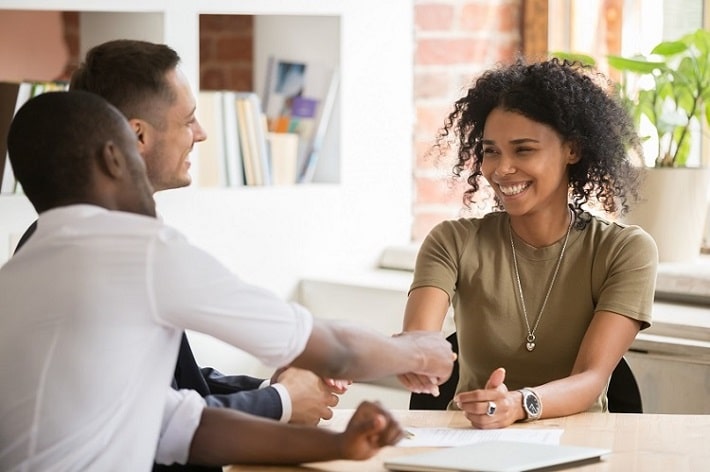 female shaking hands with new coworker before onboarding