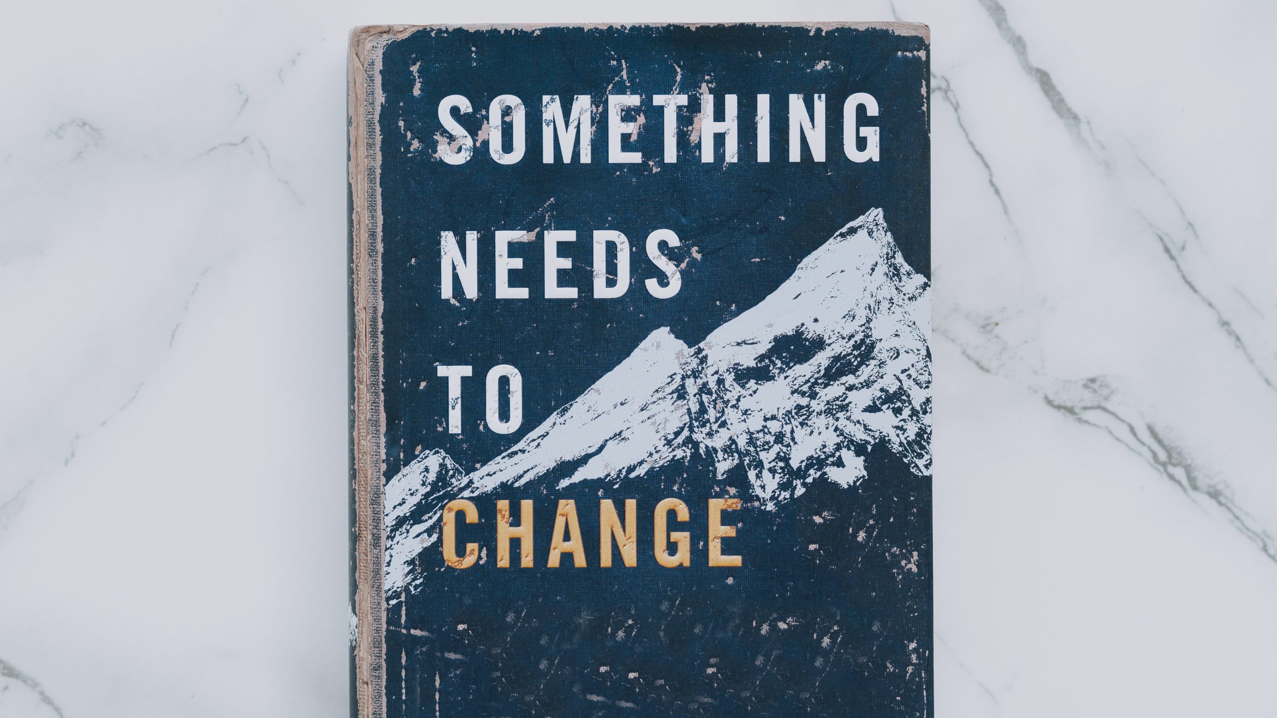 What is change management? This is reflected by a book cover that reads Something Needs To Change