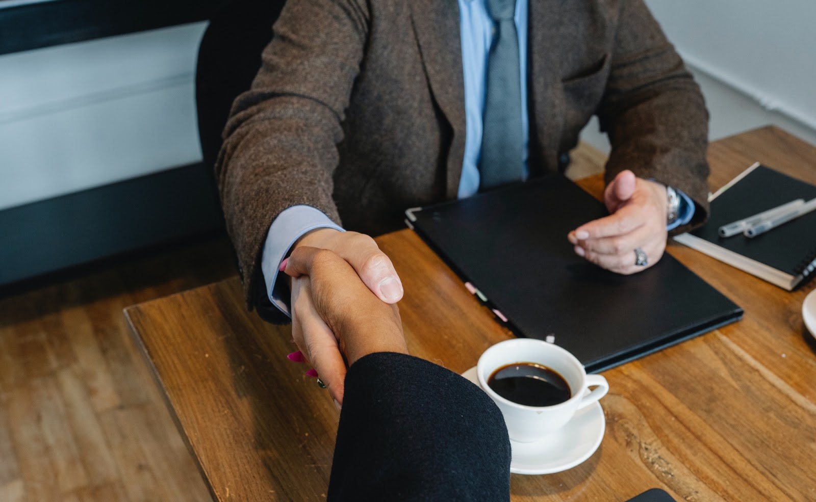 A handshake at an HR office meeting.