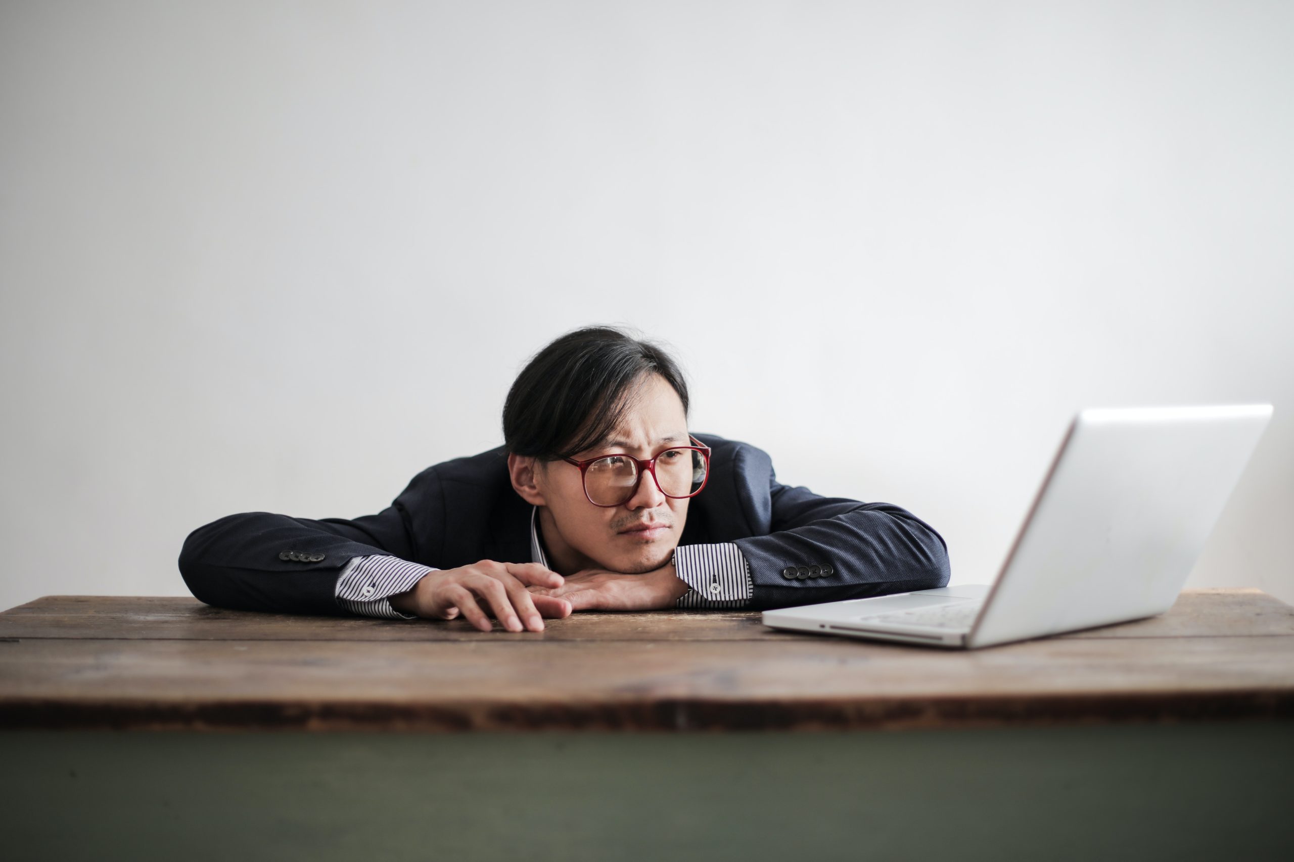 hiring manager looking at his computer with a sad look on his face