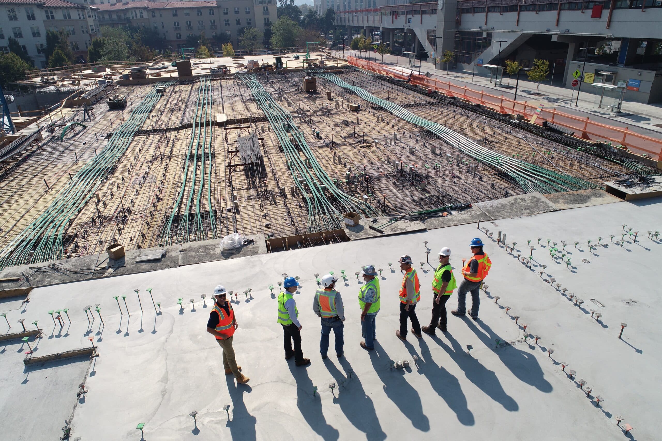 Seven construction workers standing on a roof