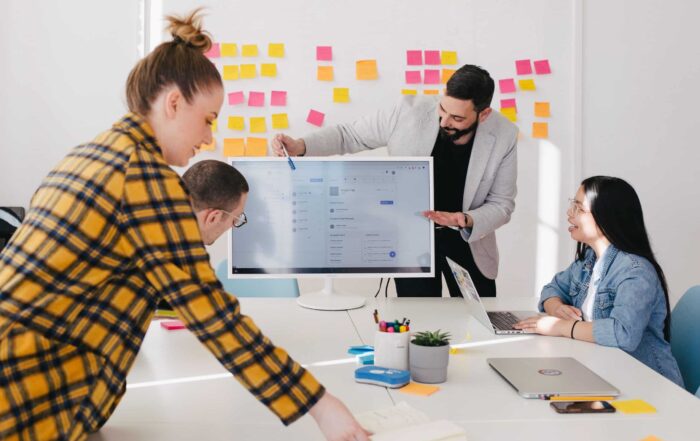 a team of HR consultants gathered around a computer screen
