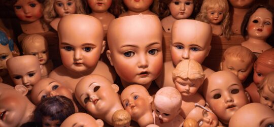 a pile of a bunch of doll heads