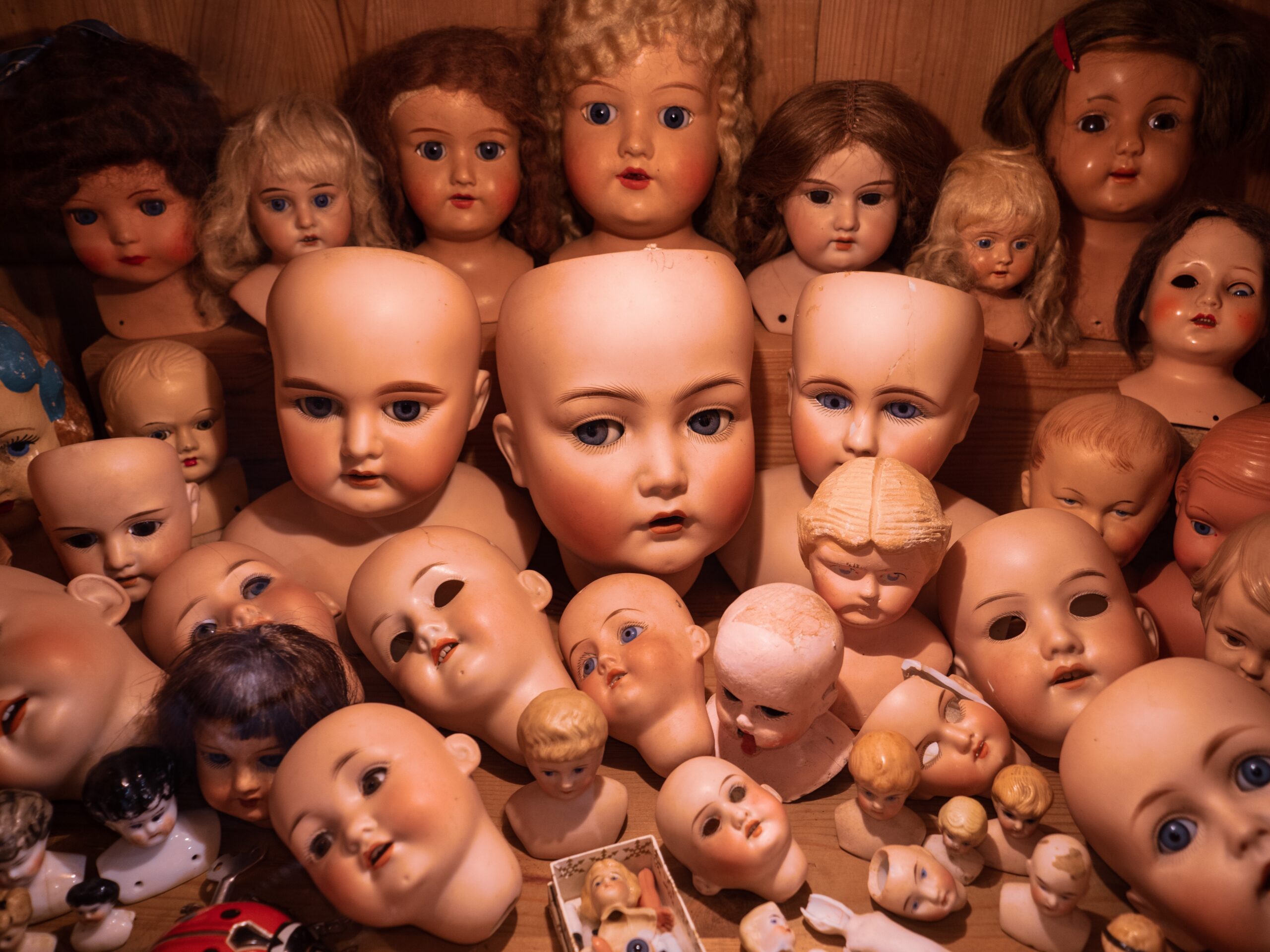 a pile of a bunch of doll heads