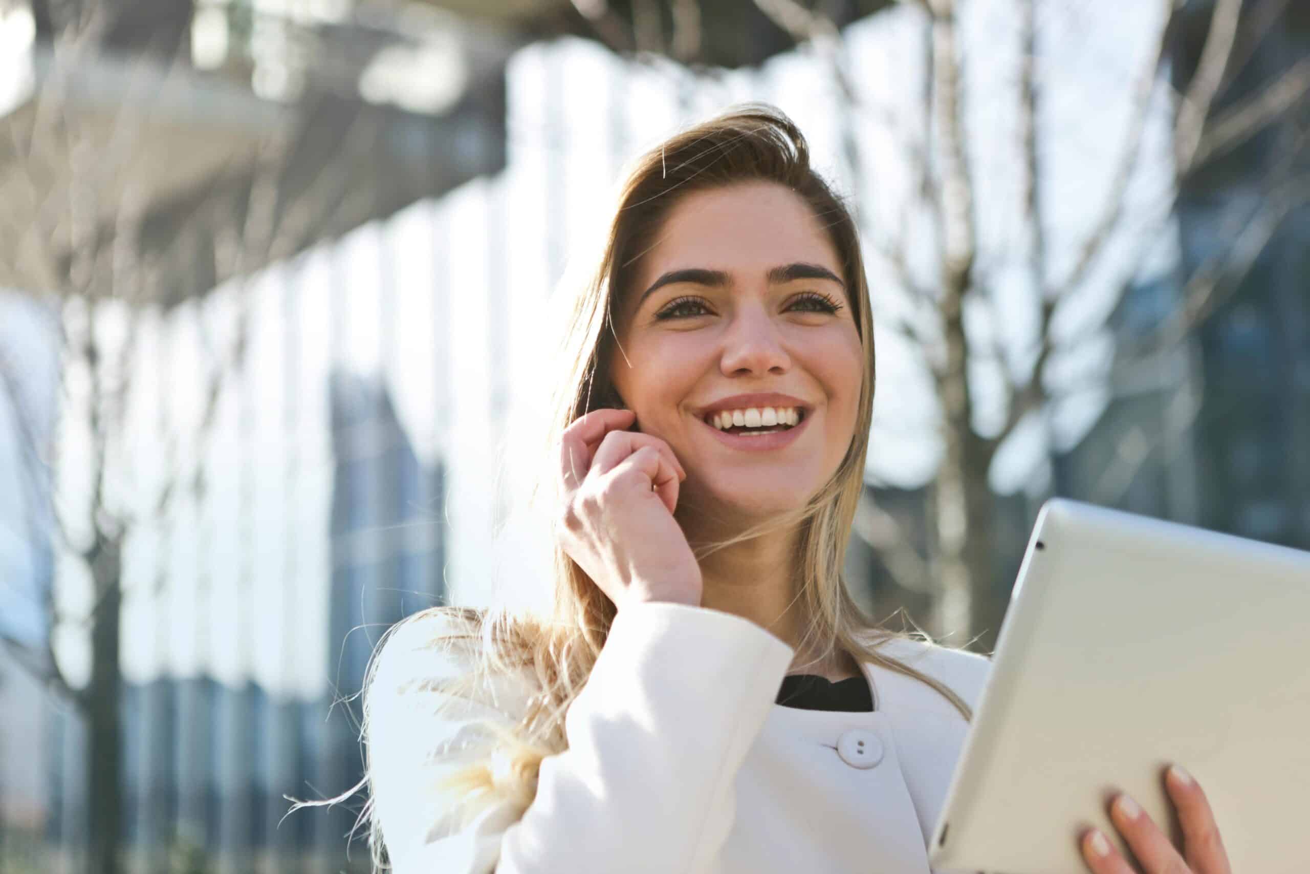 employee on phone with laptop smiling